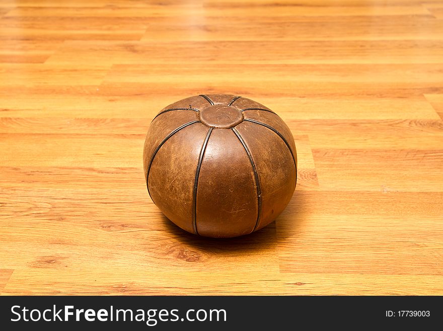 Medicinal leather ball on the gym floor