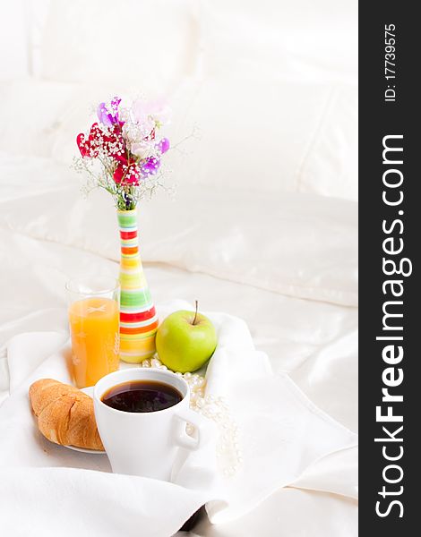 Cup of coffe and flower in vase on tray. Cup of coffe and flower in vase on tray