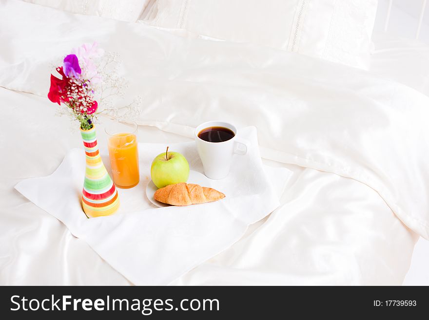 Cup of coffe and flower in vase on tray. Cup of coffe and flower in vase on tray