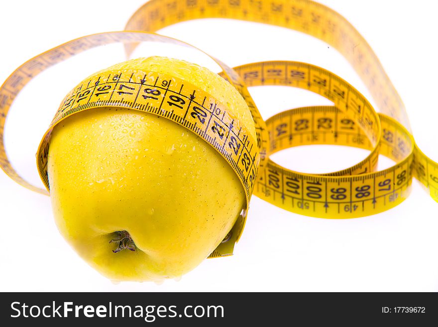 Yellow apple and ruler. Healthy lifestyle. Weight loss. Vitamins. Fruit