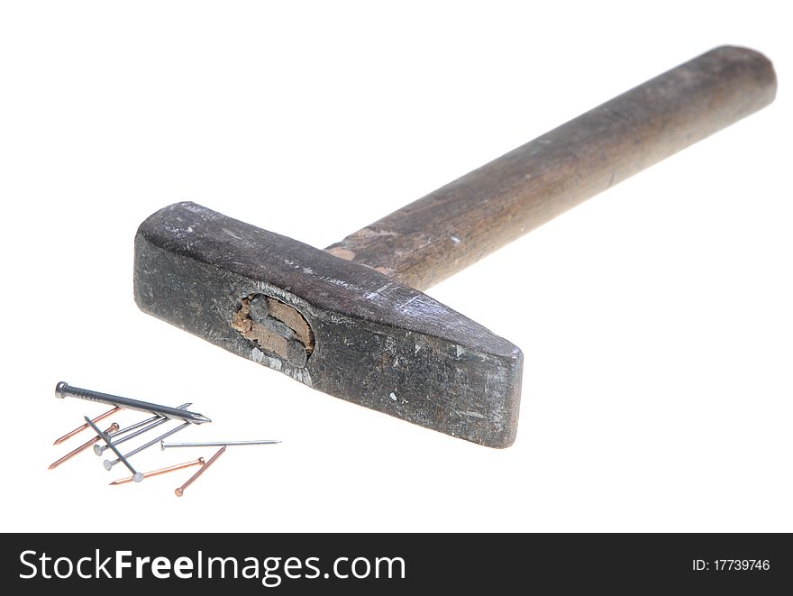 Old hammer and few nails isolated on white background