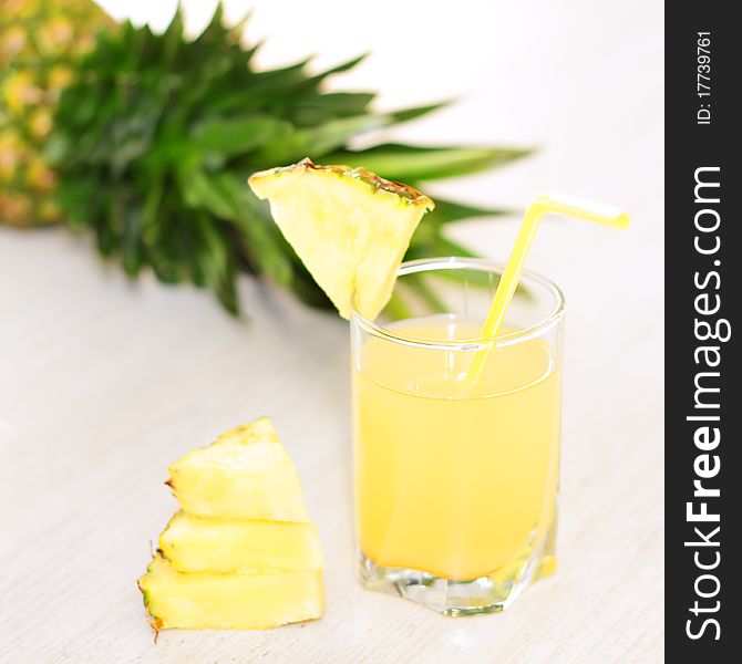 Pineapple juice and pineapple on a light background