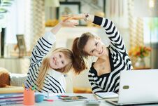 Mom And Child In Modern Living Room In Sunny Day Stretching Royalty Free Stock Image