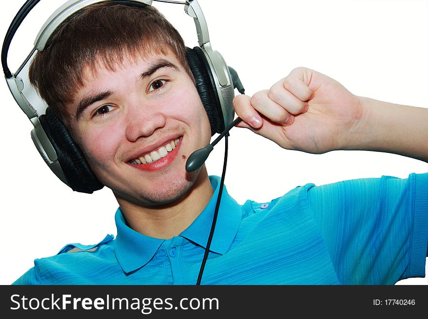 Attractive young man in a blue T-shirt with headphones isolated on white. Attractive young man in a blue T-shirt with headphones isolated on white