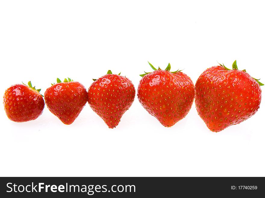 Group of fresh isolated strawberries on a white background