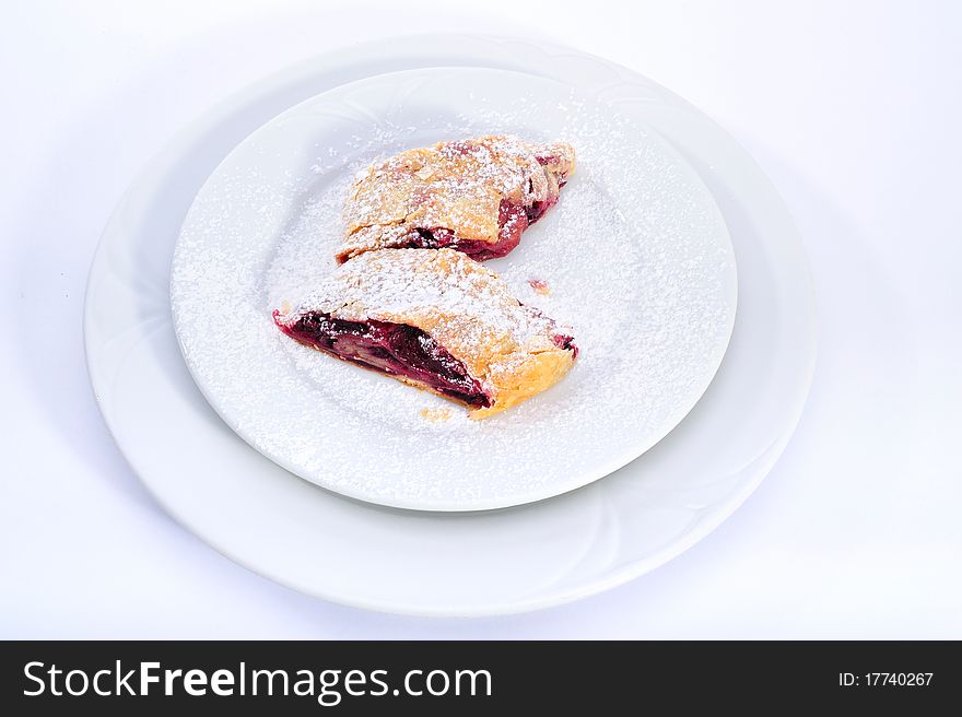 Sour cherry strudel in white plate