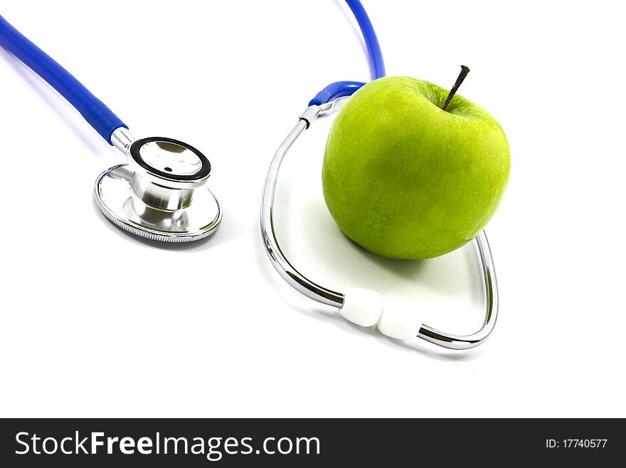 Stethoscope and green apple isolated on white background. Stethoscope and green apple isolated on white background