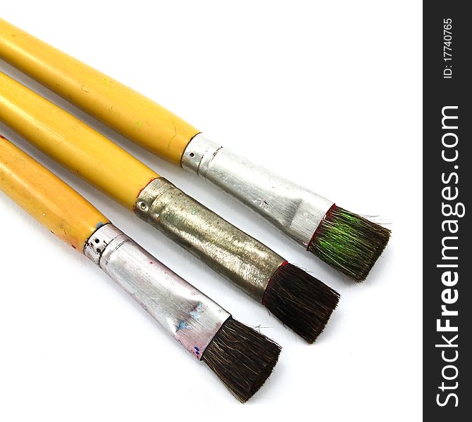 Close up of paint brushes on white background