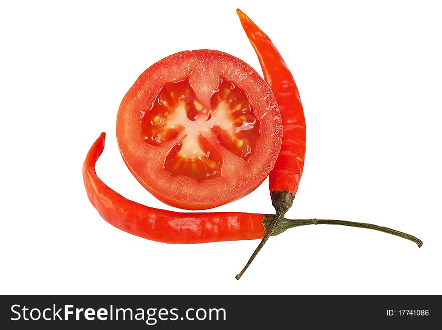 Sliced tomato and two chili peppers isolated on white background