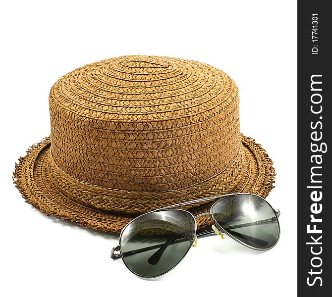 Straw hat and sunglasses isolated on a white background