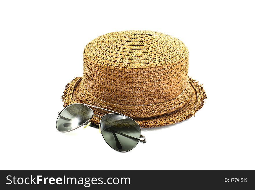 Straw hat and sunglasses isolated on a white background