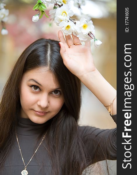 Beautiful Asian girl near a flowering apple tree