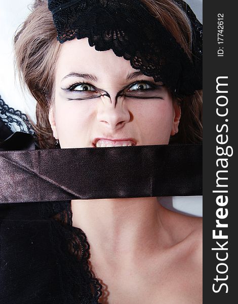 Fashion beautiful girl with extraordinary make up and a black ribbon