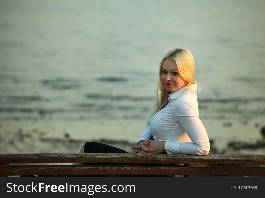 Woman portrait lake on background