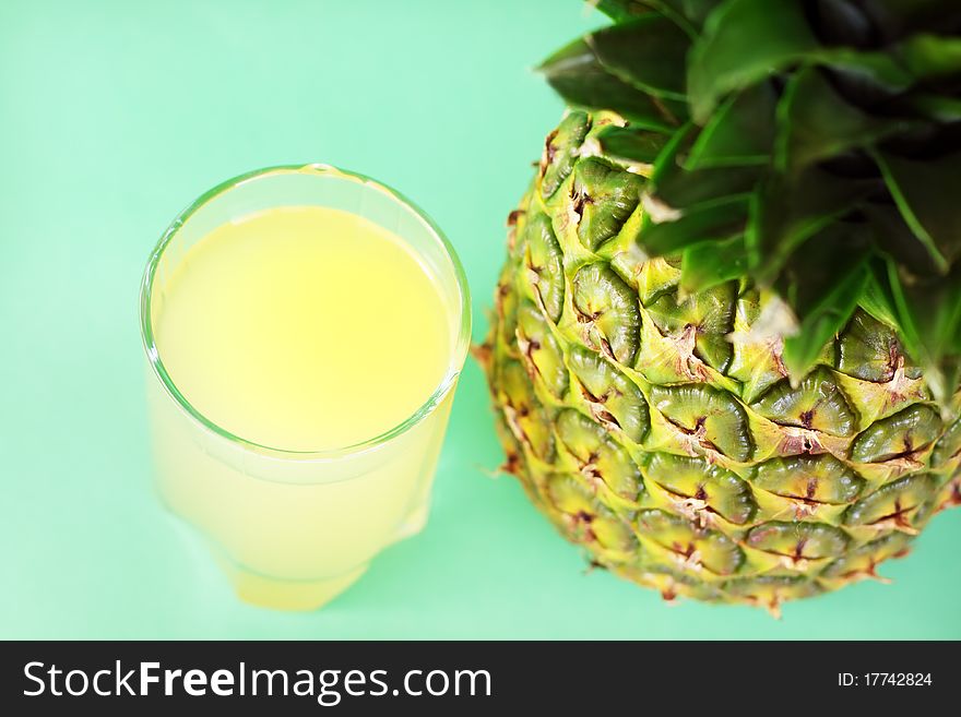 Pineapple juice and pineapple on a light background