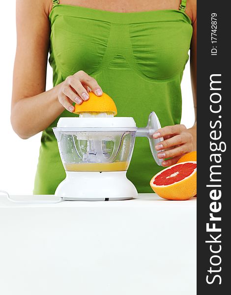Woman squeezes juice by juicer