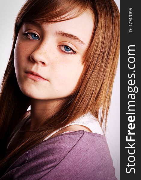 A beautiful young girl looking at the camera on a white background. A beautiful young girl looking at the camera on a white background.