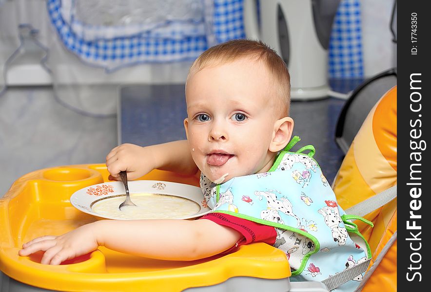 Little kid eating a big milk soup spoon. Little kid eating a big milk soup spoon