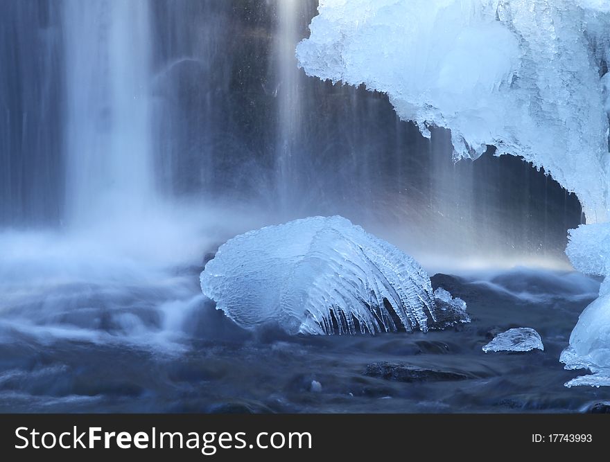 Frozen octopus and waterfall on the winter stream