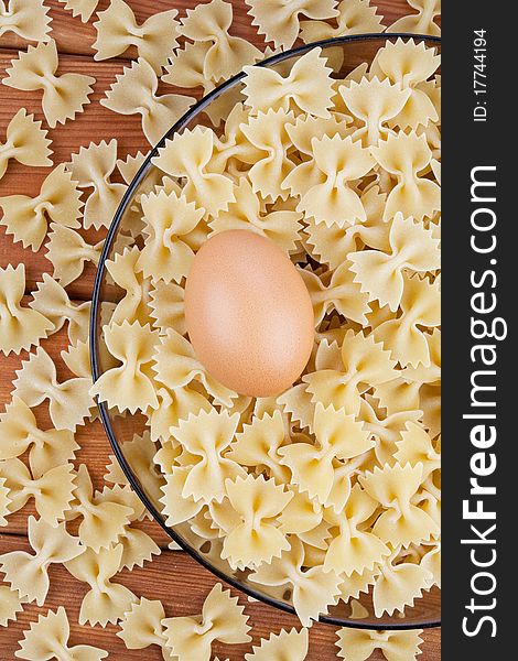 Uncooked pasta with raw egg. Uncooked pasta with raw egg