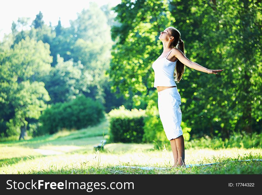 Yoga woman on green park background