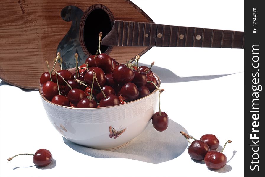 Scene of cherry with mandolin isolated on white background