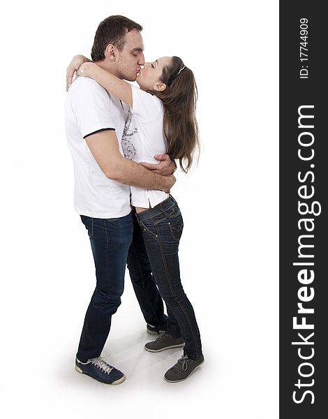 Young adults man and woman in casual style stand on white isolation. Young adults man and woman in casual style stand on white isolation