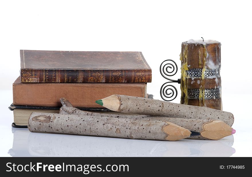 Vintage books, wooden pencils and a candle