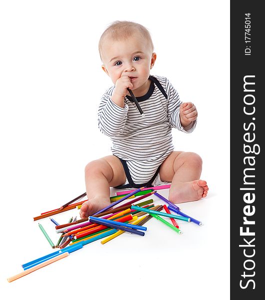 A little cute boy with markers and pencils. isolated on a white background