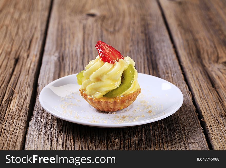 Fruit-topped tart with custard filling - closeup. Fruit-topped tart with custard filling - closeup