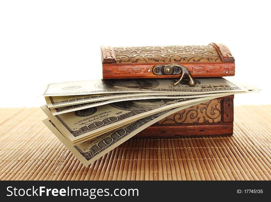 Toy wooden chest filled with the new one hundred dollar bills. Isolated on a white background. Toy wooden chest filled with the new one hundred dollar bills. Isolated on a white background