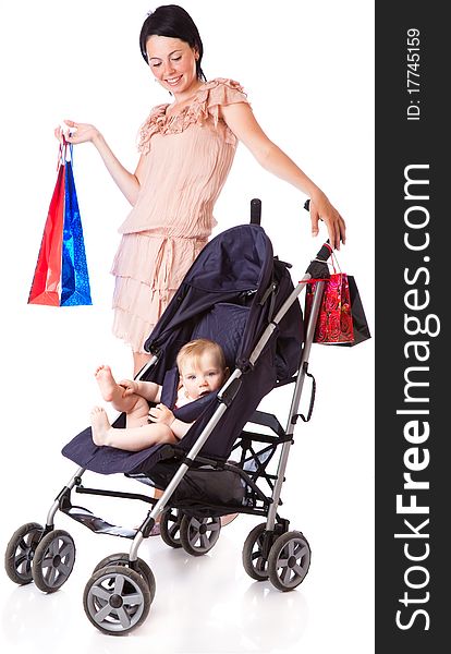 A young woman is standing near a pram and holding bright paper bags. isolated on a white background