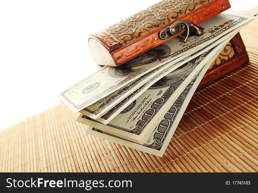 Toy wooden chest filled with the new one hundred dollar bills. Isolated on a white background. Toy wooden chest filled with the new one hundred dollar bills. Isolated on a white background