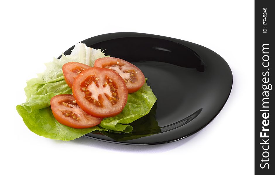 Tomatoes and salad on plate. Tomatoes and salad on plate