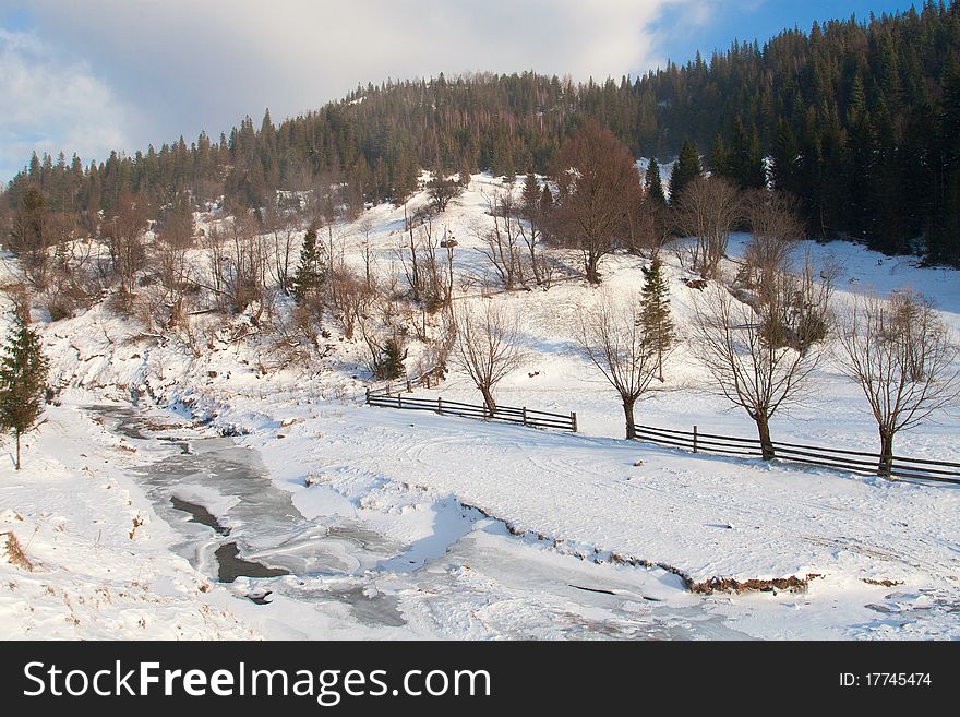 Frozen river on a winter mountain landscape