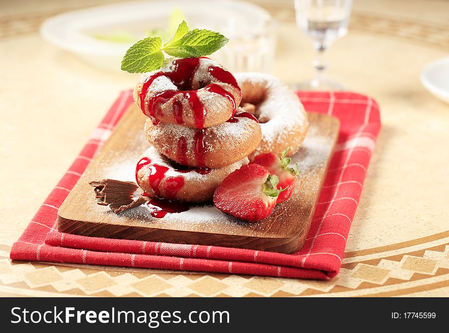 Ring doughnuts poured with syrup - closeup