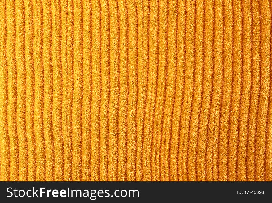 Texture of the orange sand which rakes made strips. Background