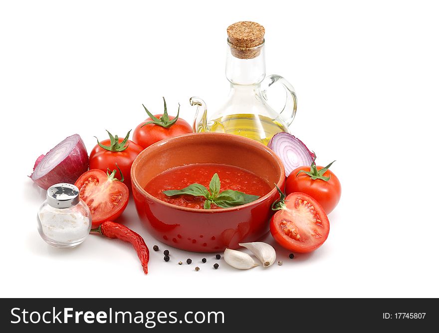 Tomatoes, onions, peppers, garlic, olive oil and basil over white. Tomatoes, onions, peppers, garlic, olive oil and basil over white