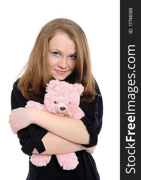 Beautiful girl  embraces teddy bear. On a white background