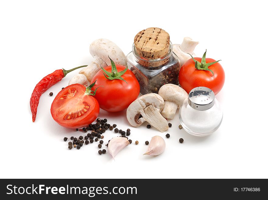 Tomatoes, mushrooms, peppers, garlic and salt over white. Tomatoes, mushrooms, peppers, garlic and salt over white