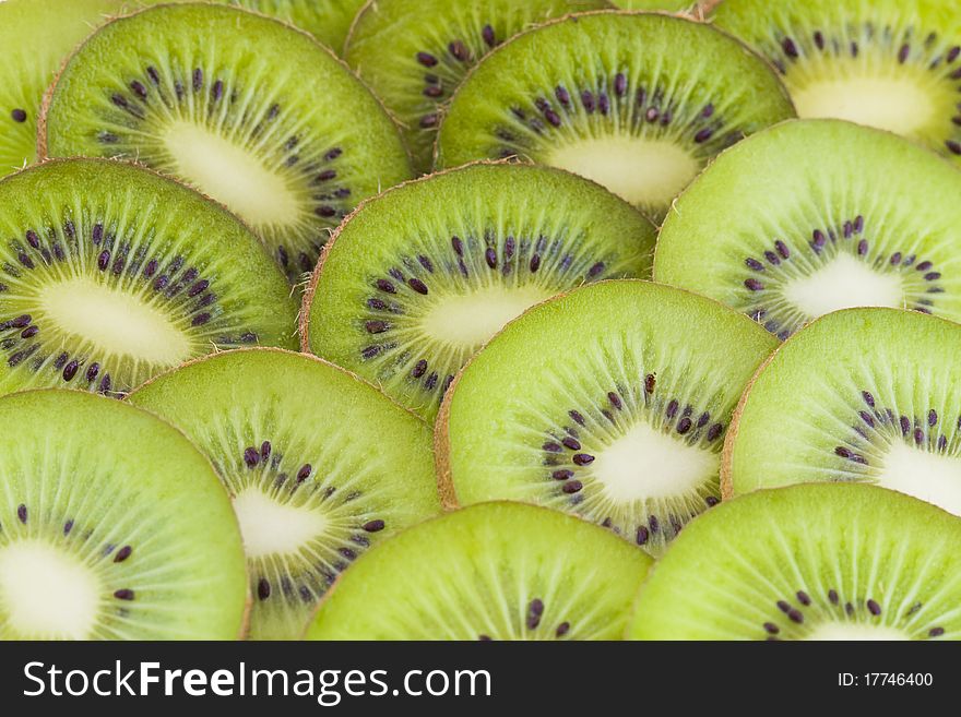 Fresh kiwi slices, green fruits background