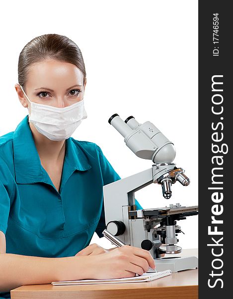 Female medical doctor using microscope in a laboratory on white background. Female medical doctor using microscope in a laboratory on white background