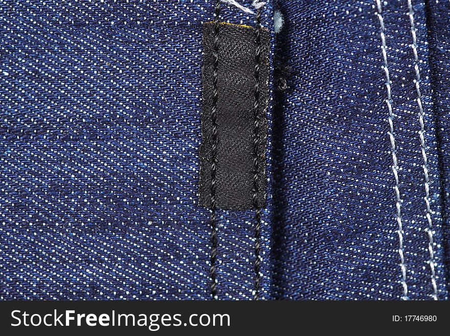 Showing lines and texture of blue jeans, back pocket label. Showing lines and texture of blue jeans, back pocket label.