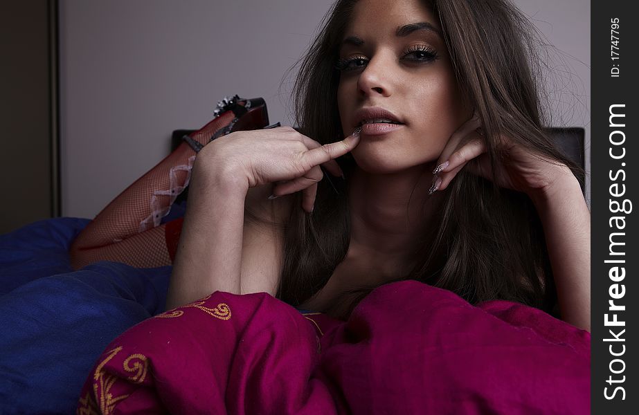 Attractive young woman lying in bed. Photo.