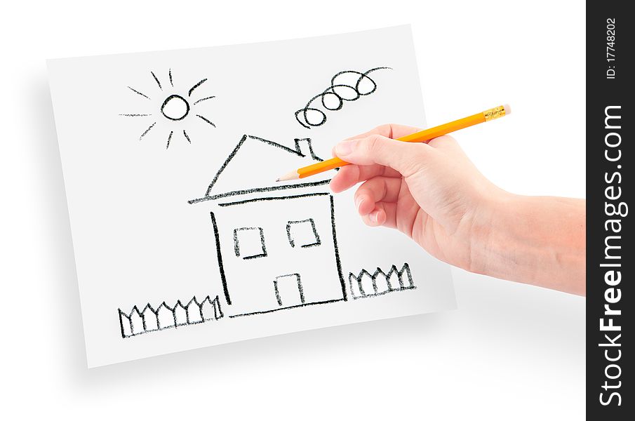 Woman's hand with the pencil drawing the dream home on a white sheet of paper