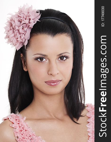 Portrait of young woman in pink dress smiling against white background