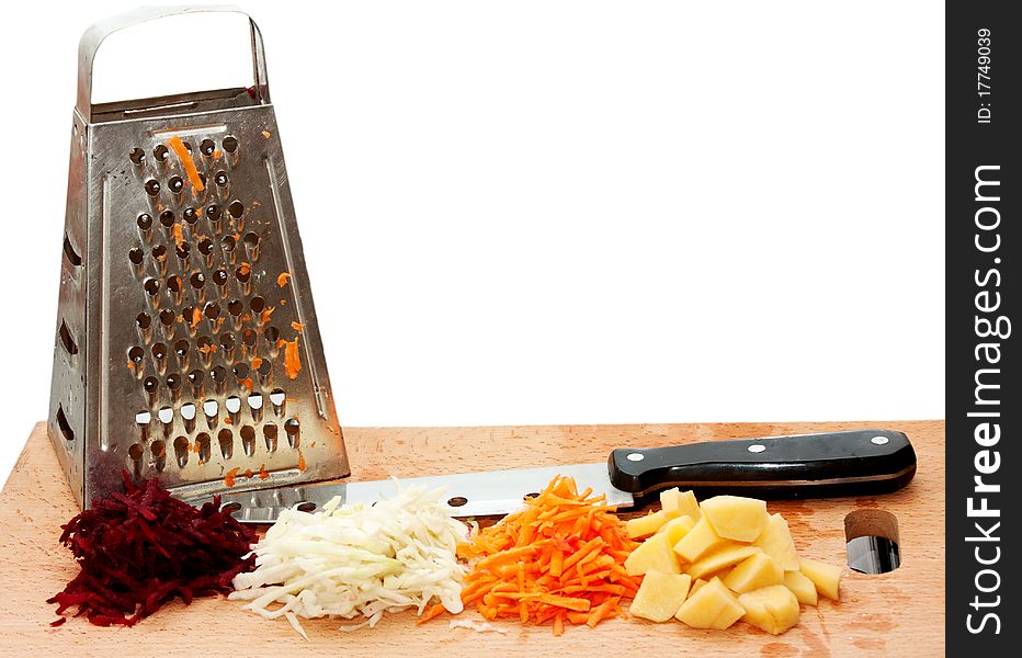 Grated fresh fruits, grater and a knife on a cutting board