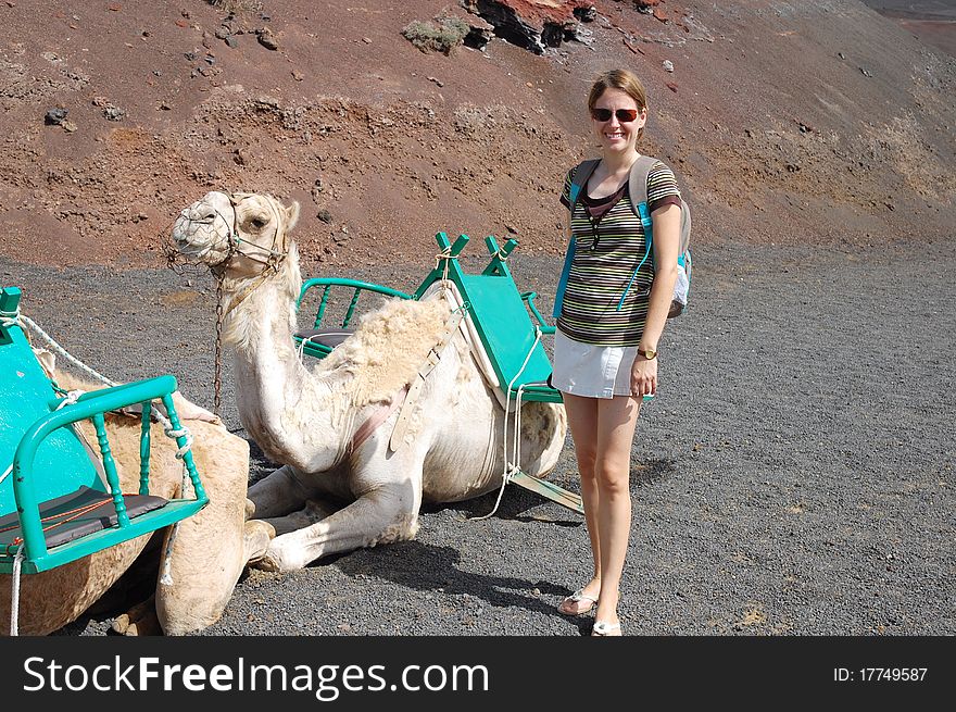 Young woman camel in timanfaya national park in lanzarote. Young woman camel in timanfaya national park in lanzarote