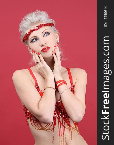 Beautiful fashion model in red looking up