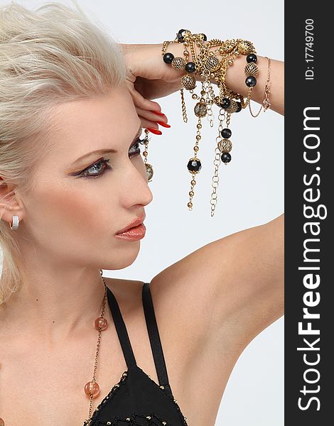 Fashion portrait of professional model with gold jewelry